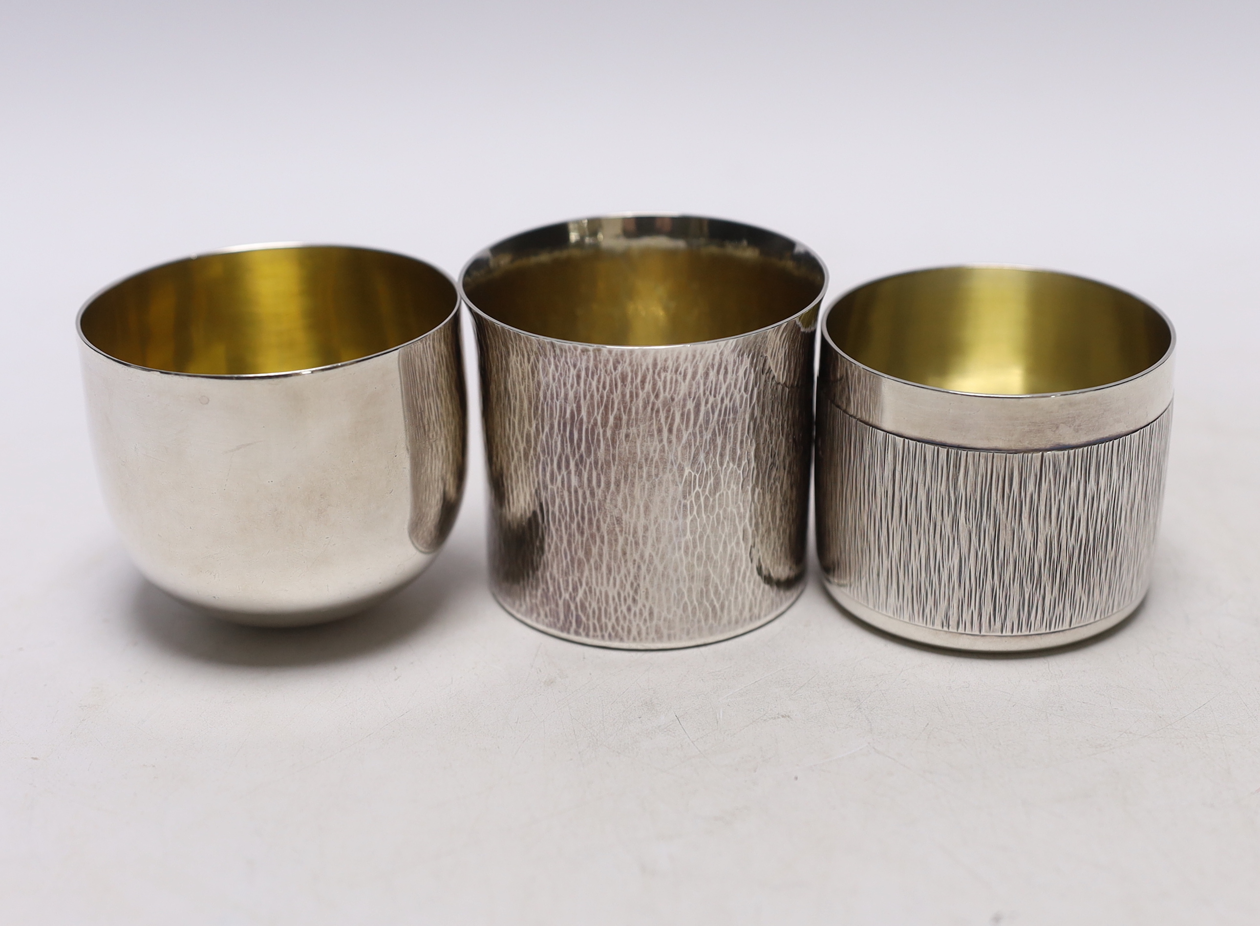 A modern Irish silver tumbler cup by Royal Irish Silver Co, height 59mm and two other modern silver beakers, 11.5oz.